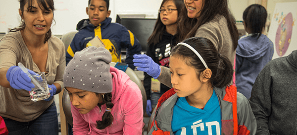 Students participating in youth outreach program laboratory exploration exercise