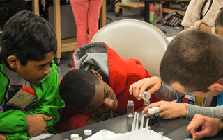 Students in youth outreach program participating in laboratory exploration and learning exercise