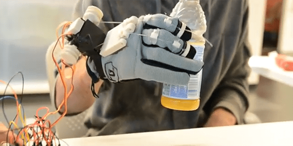 Robotic hand grasps a juice bottle at UW CSNE hackathon