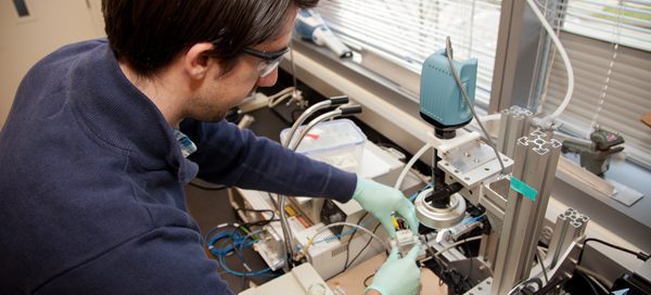 Student working with bioengineering laboratory equipment and devices