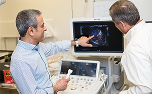 Researchers examining ultrasound equipment