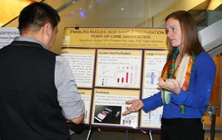 Students discussing research poster at UW Bioengineering BioEngage symposium