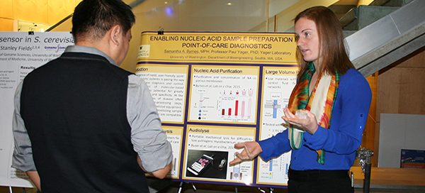 Students discussing research poster at UW Bioengineering BioEngage symposium