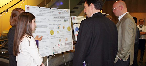 UW Bioengineering students discussing research poster at BioEngage symposium