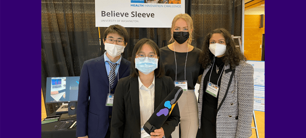Four students holding device at tradeshow-style competition