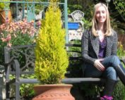 Dr. Alyssa Taylor sitting on a bench in a garden