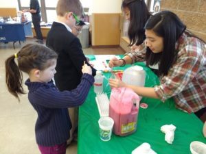 Student and child at iGEM outreach event