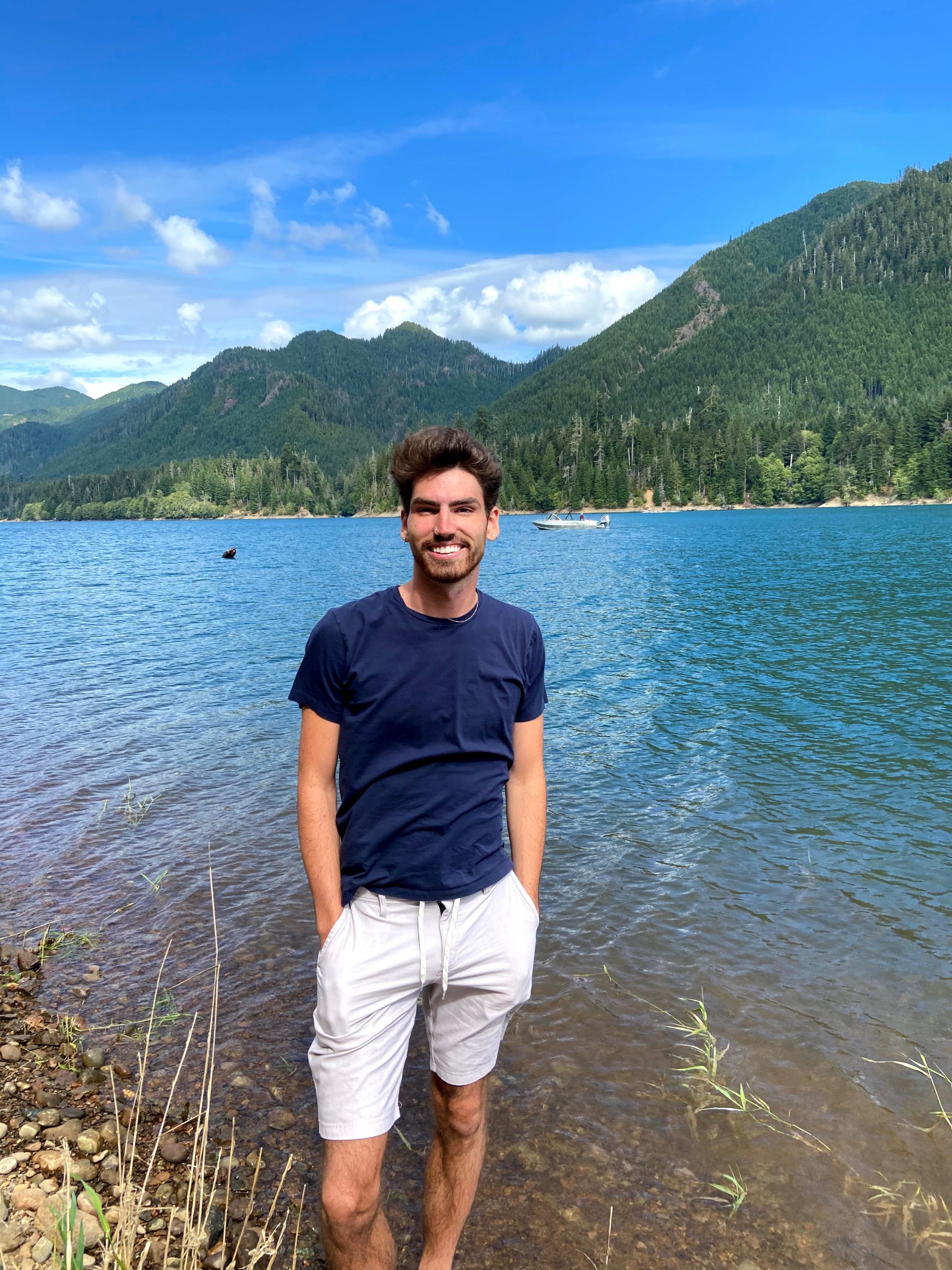 Jamison Siebart in front of lake and mountains, wide shot