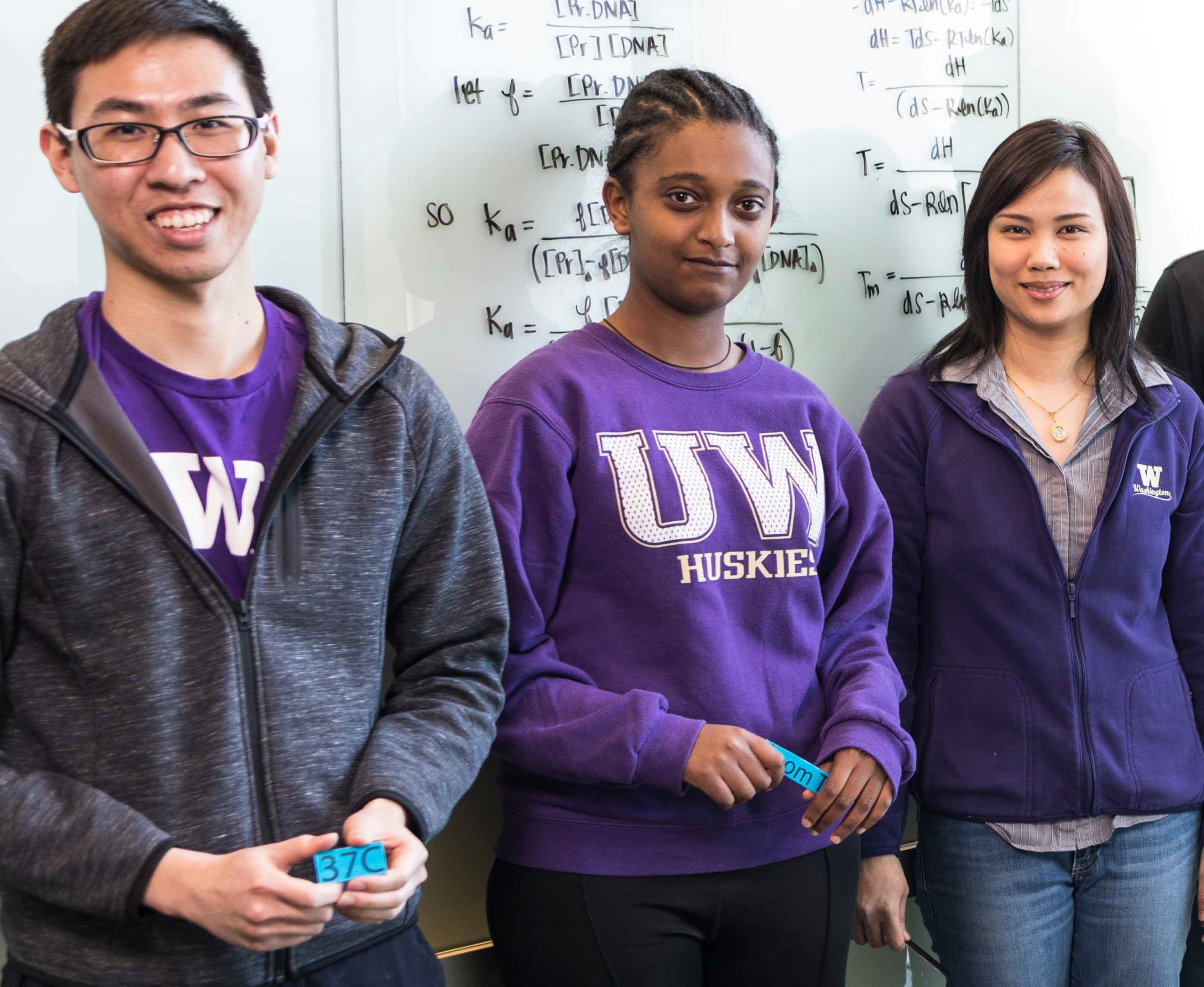 Three students in Lutz lab