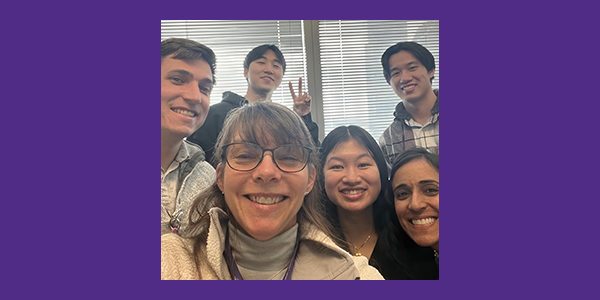 The six members of the WiseMind team huddle together for a selfie. One gives a peace sign.